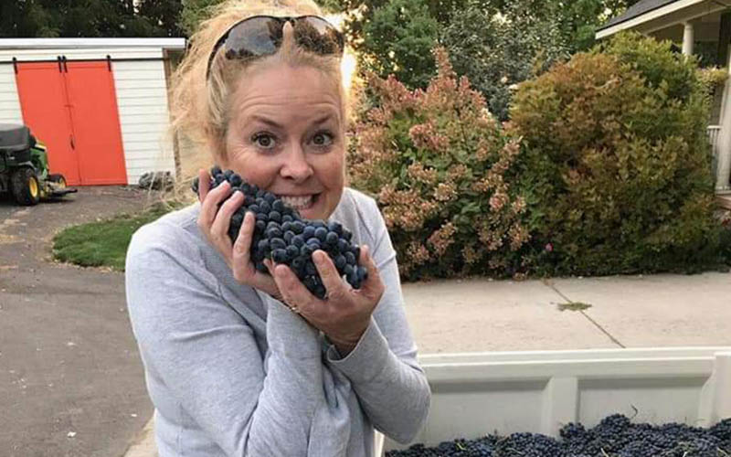 WIT From Client 800x500_0015_Gina grapes Woman holding harvested blueberries, smiling outside.