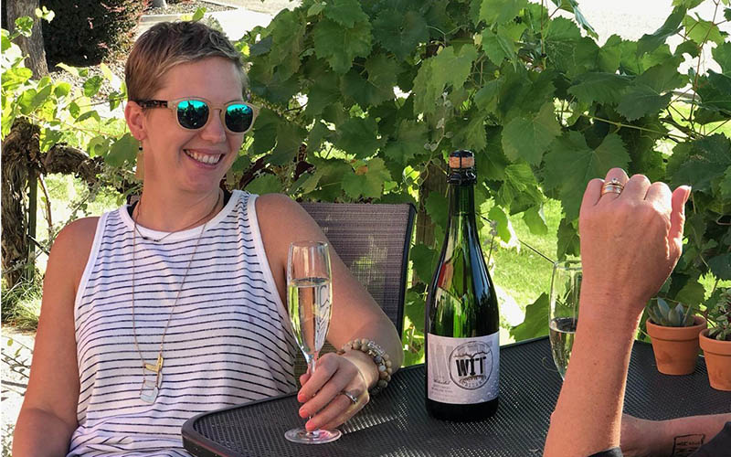 WIT From Client 800x500_0019_Bubbles3 Woman enjoying wine outdoors with friend.