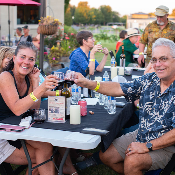 Couple toasting wine at outdoor event