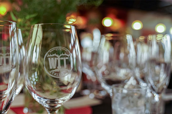 Restaurant wine glasses with etched logo on table.