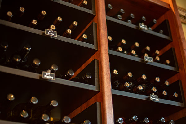 Wine bottles stored on a wooden rack