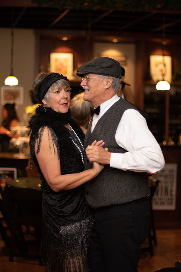 Smiling couple dancing at a party.