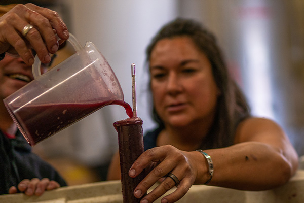 Pouring red liquid into a measuring cylinder
