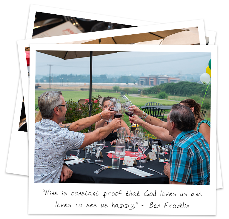 Ben-Franklin---polaroid-stack-experience Group toasting with wine at outdoor table.