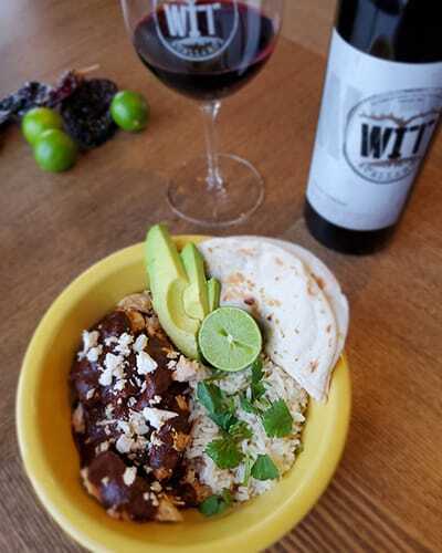 Mexican bowl with avocado, lime, rice, and tortillas.