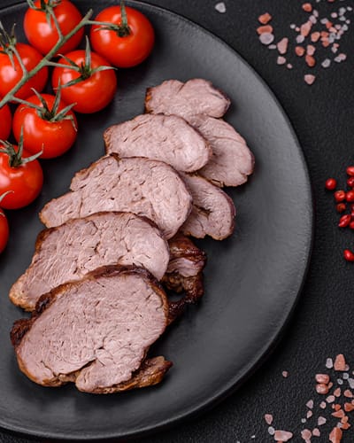 Sliced beef on plate with cherry tomatoes