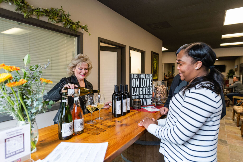 Women enjoying wine tasting in a social setting.