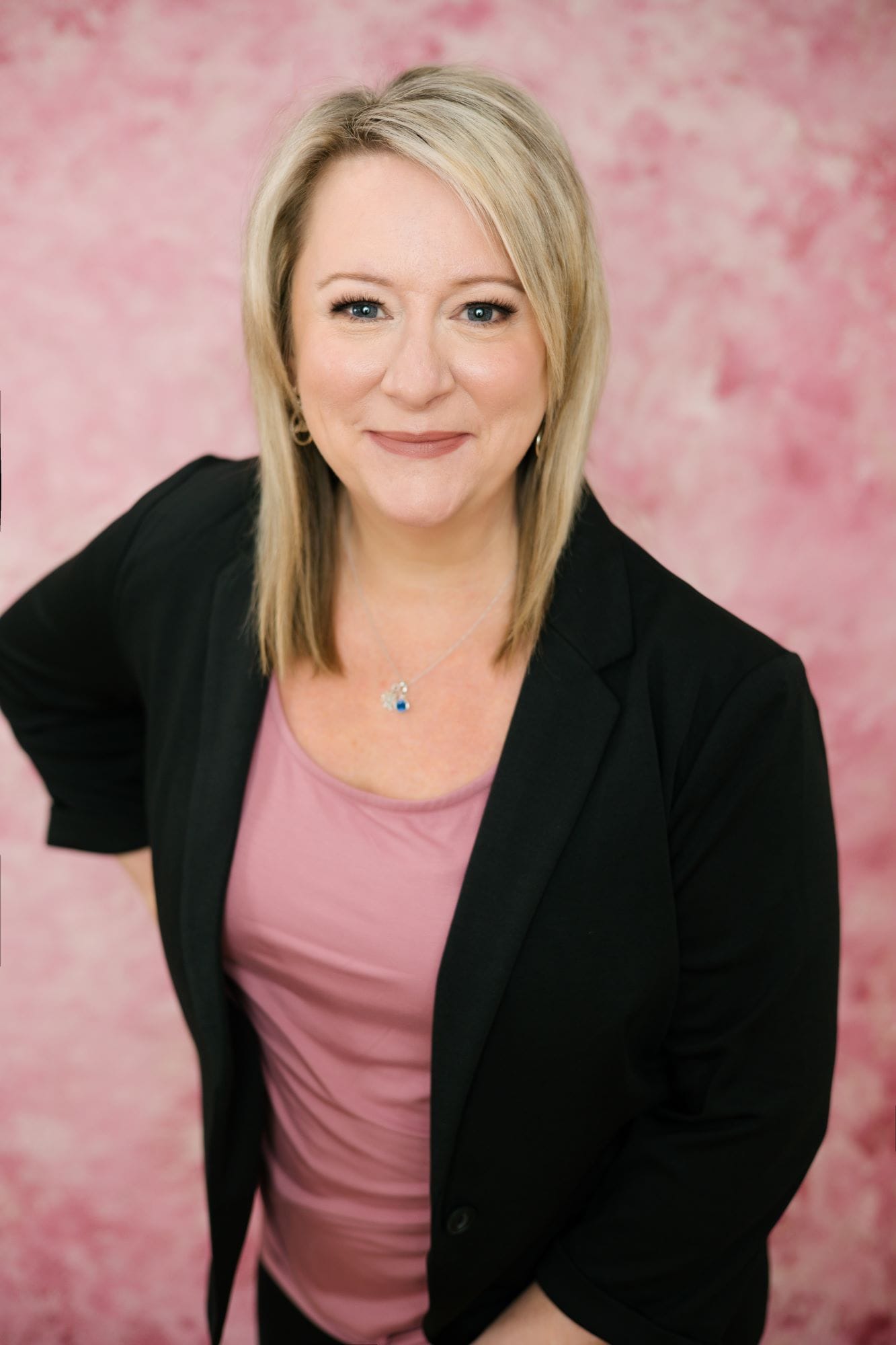 Smiling woman with pink background