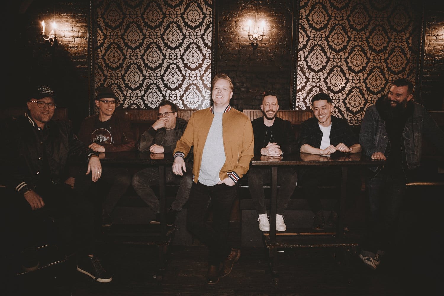 Group of people in a stylish room, smiling.