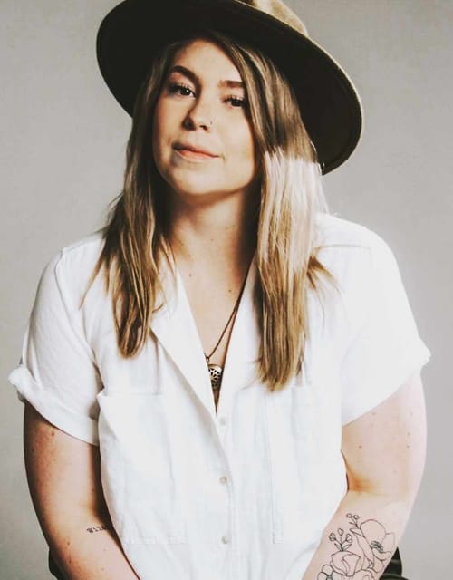 beclynn-music Person in hat with tattoo on arm.