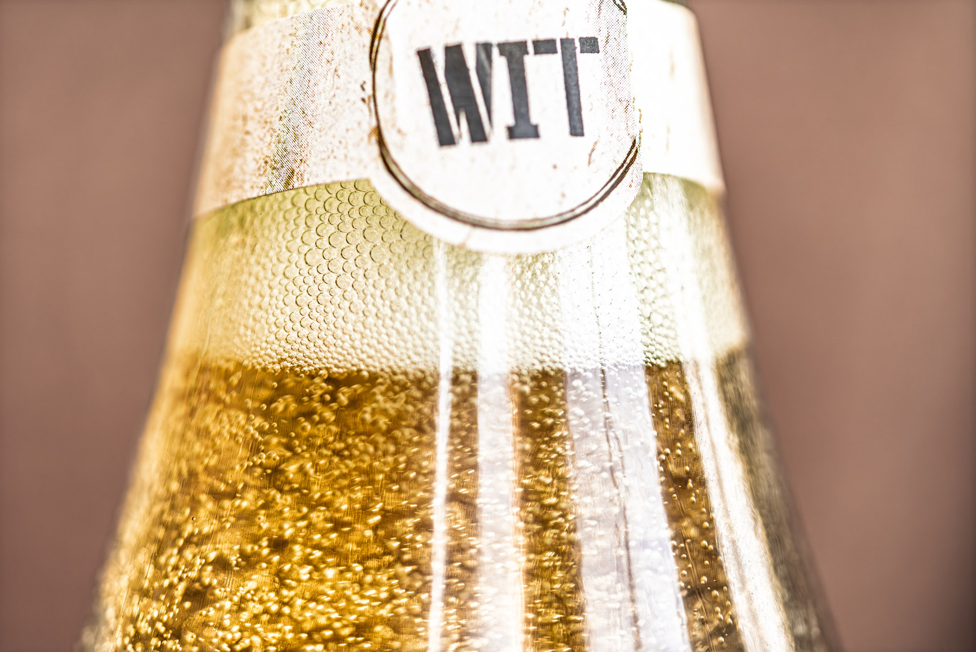 WIT Cellars_Wine Club Images-01017 Close-up of beer bottle with 'WIT' label.