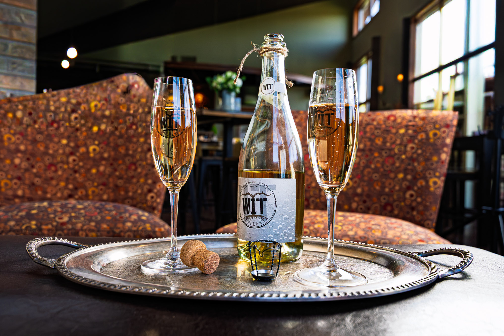 WIT Cellars_Wine Club Images-01120 Champagne bottle and glasses on a silver tray.