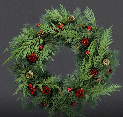 Festive wreath with pinecones and red berries
