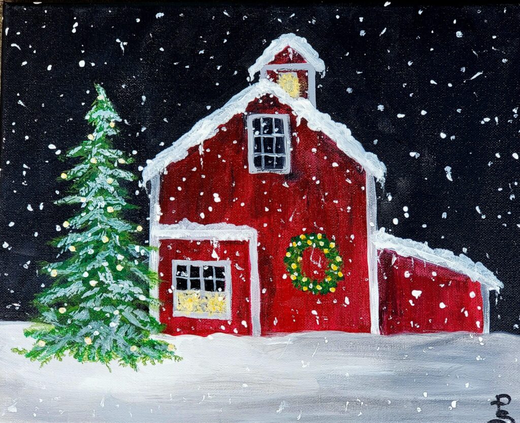 Snowy red barn with Christmas wreath and tree.