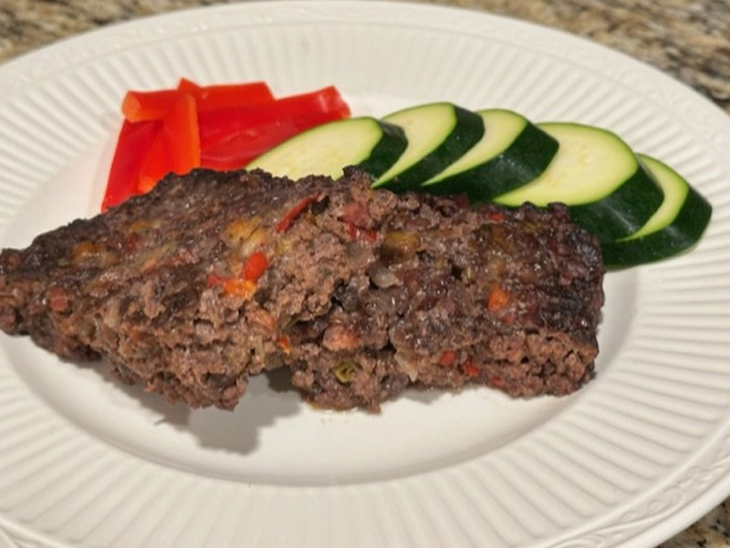 Meatloaf with sliced zucchini and red peppers
