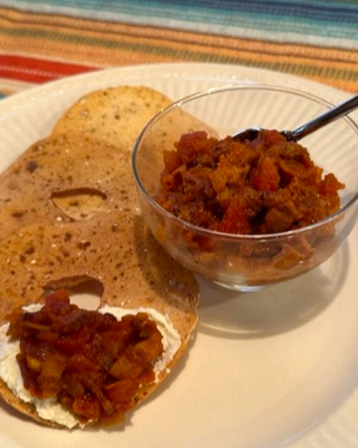 Bruschetta with topping on bagels and in bowl.