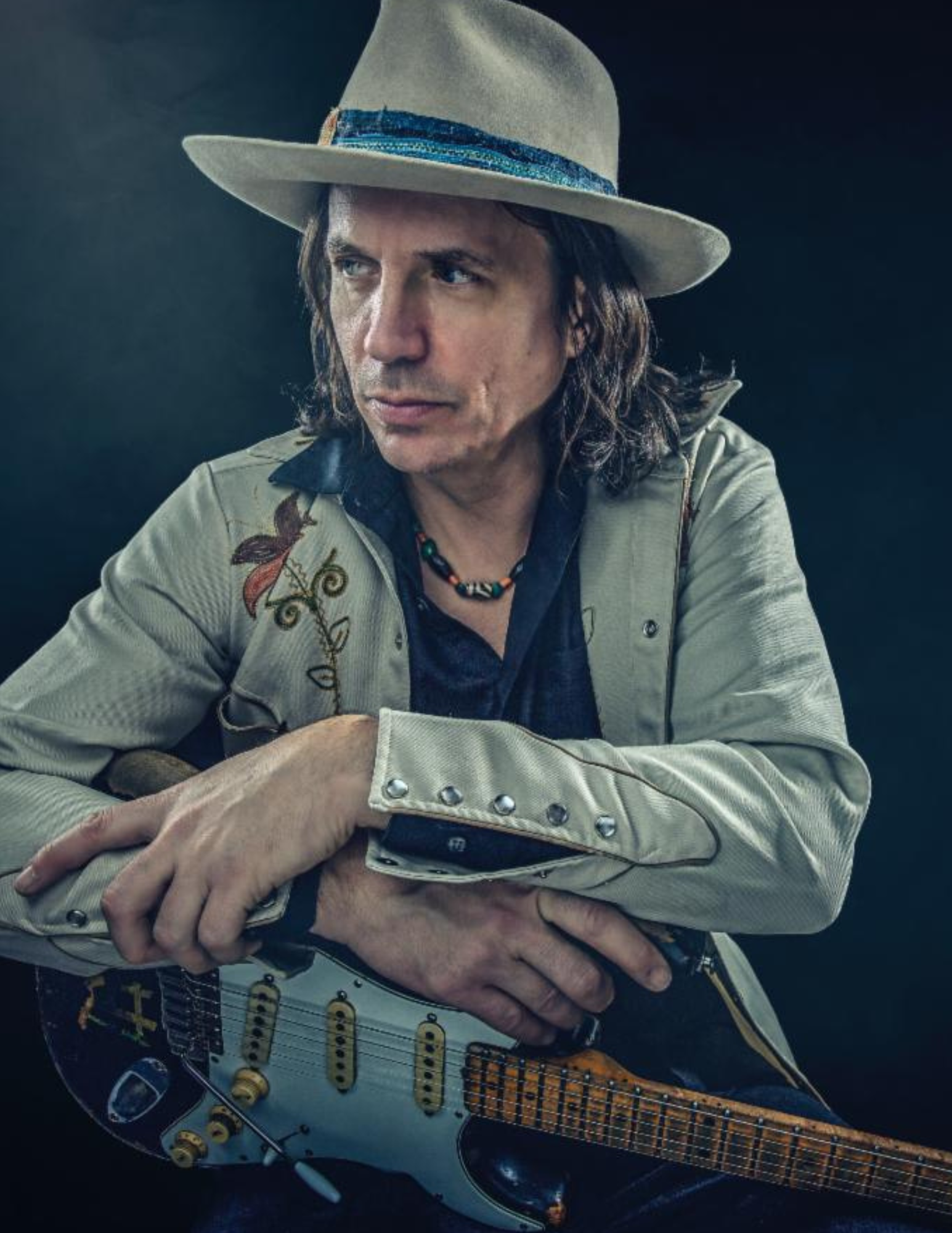 Man in hat with electric guitar