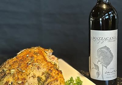 Roast chicken with red wine on the table.