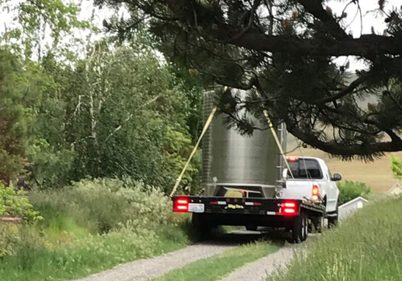 Driveway Truck hauling tank on rural road