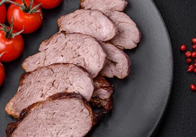 Sliced beef on plate with cherry tomatoes