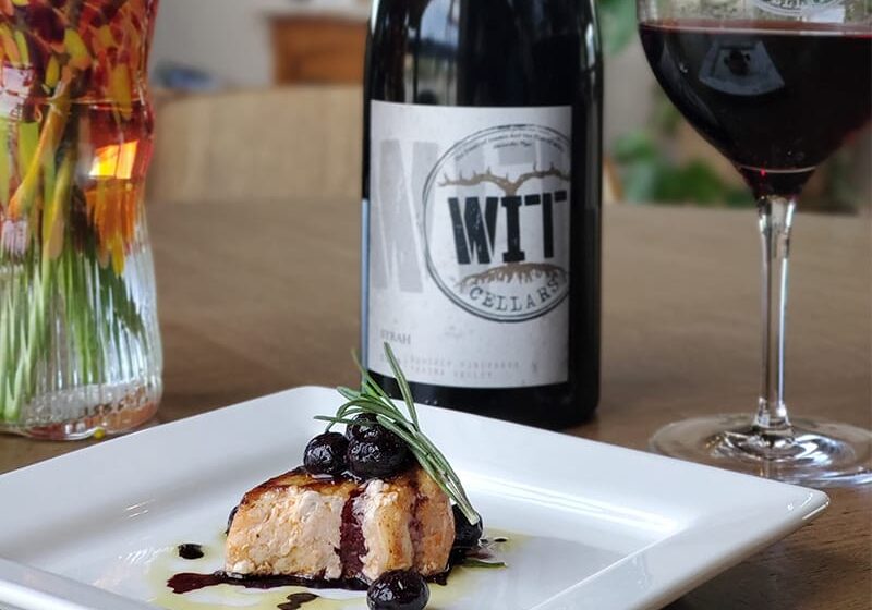 Gourmet salmon dish with red wine pairing.