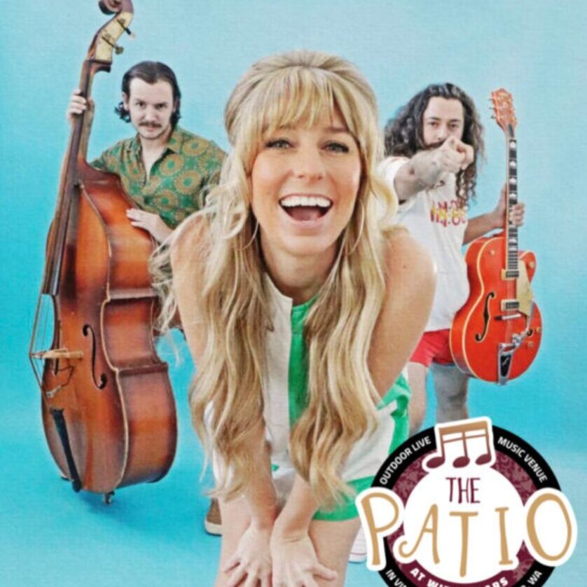 Three musicians posing with bass and guitar