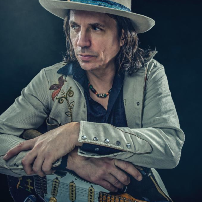 Man in hat with electric guitar