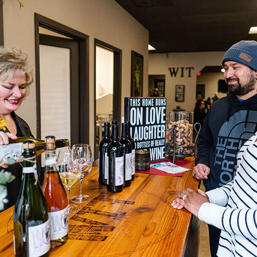 People enjoying wine tasting at a local winery.