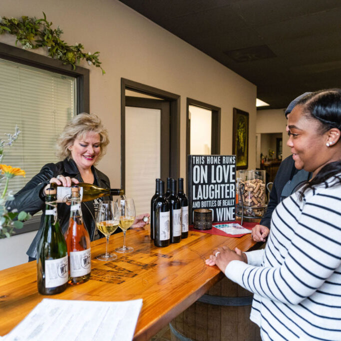 Women enjoying wine tasting in a social setting.